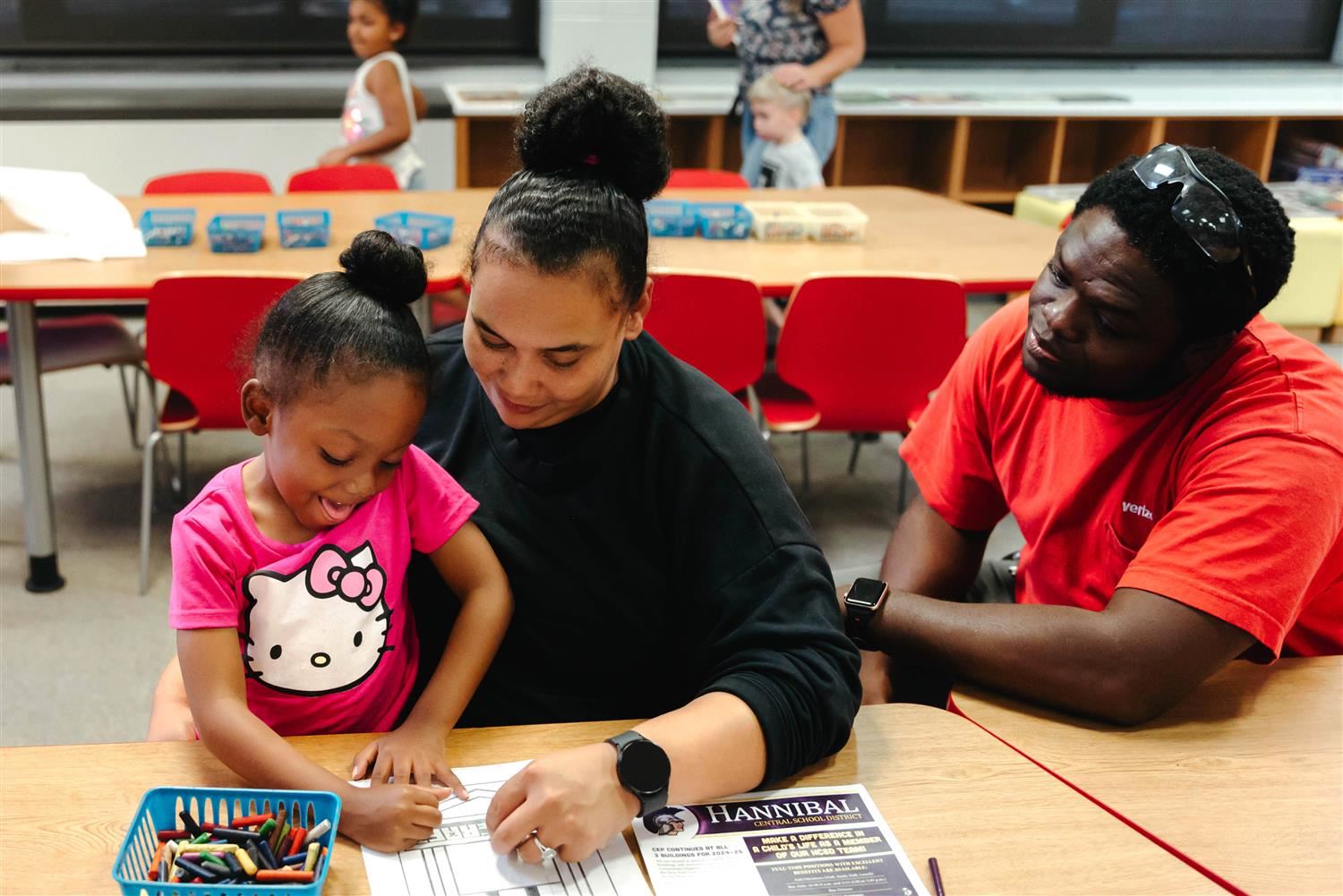  An FES student and her family enjoy an activity during Open House.